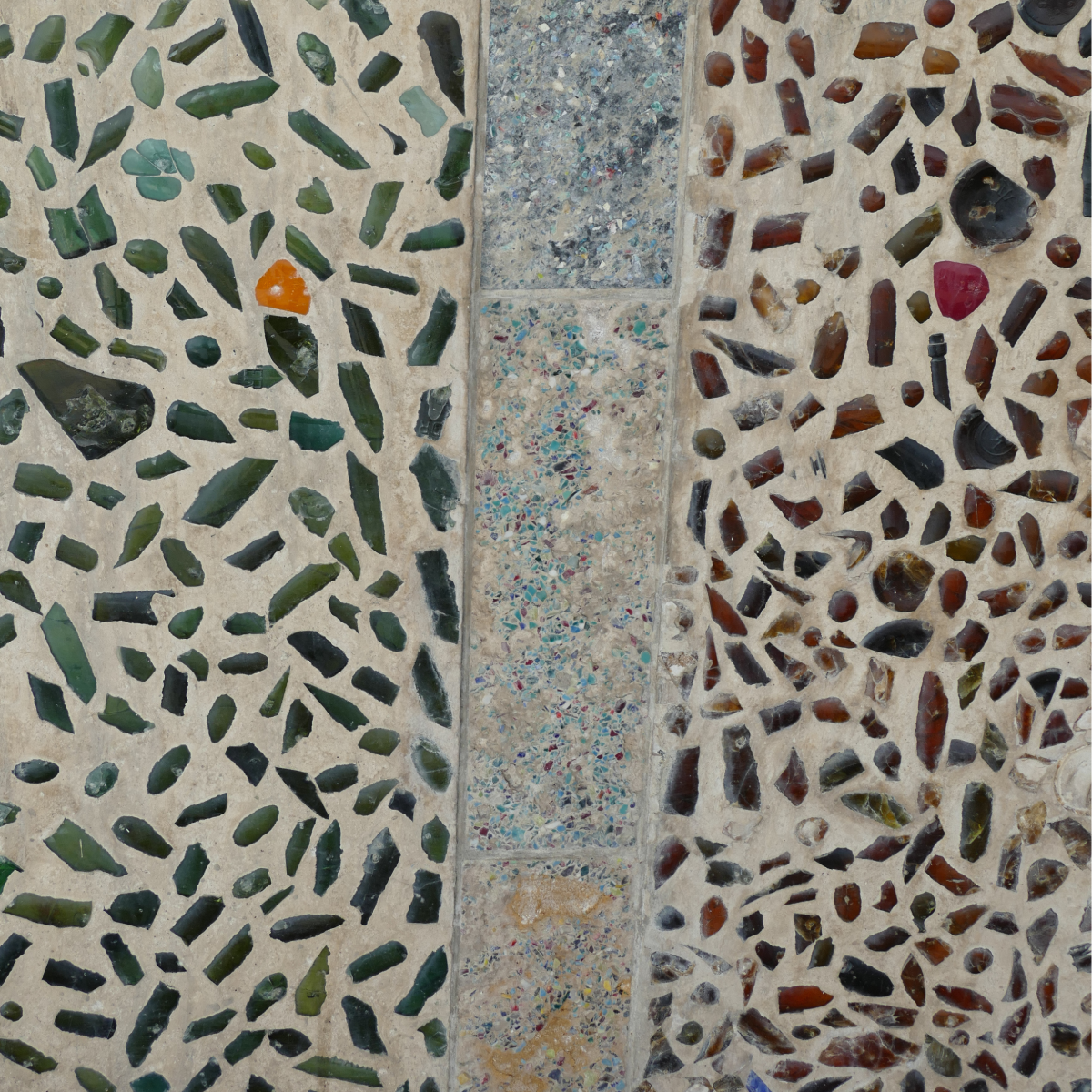 Close-up of Bottle Alley mosaics in Hastings, showing concrete panels embedded with colourful glass bottle fragments
